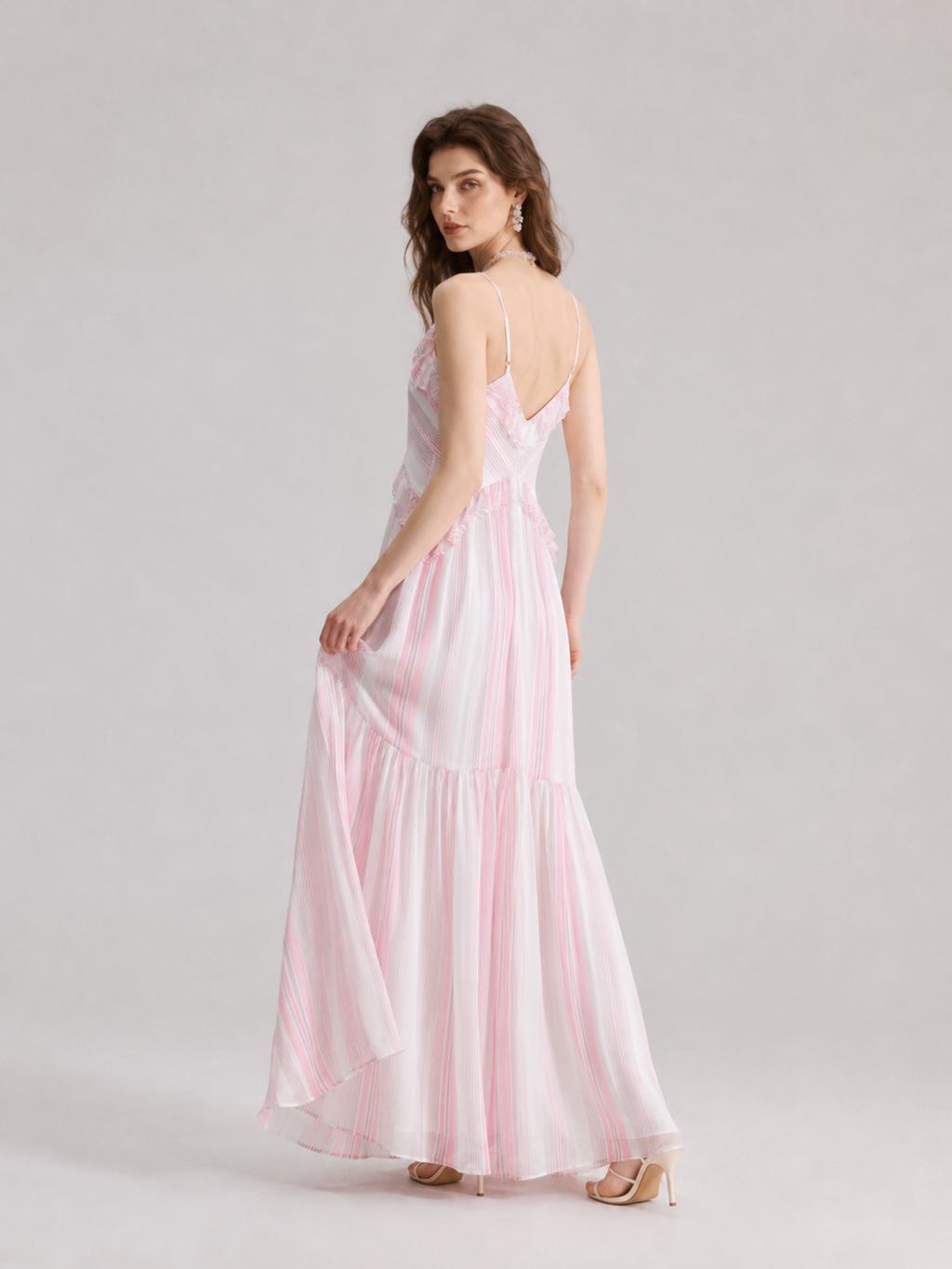 A French-style slip dress with pink and white stripes and ruffle details
